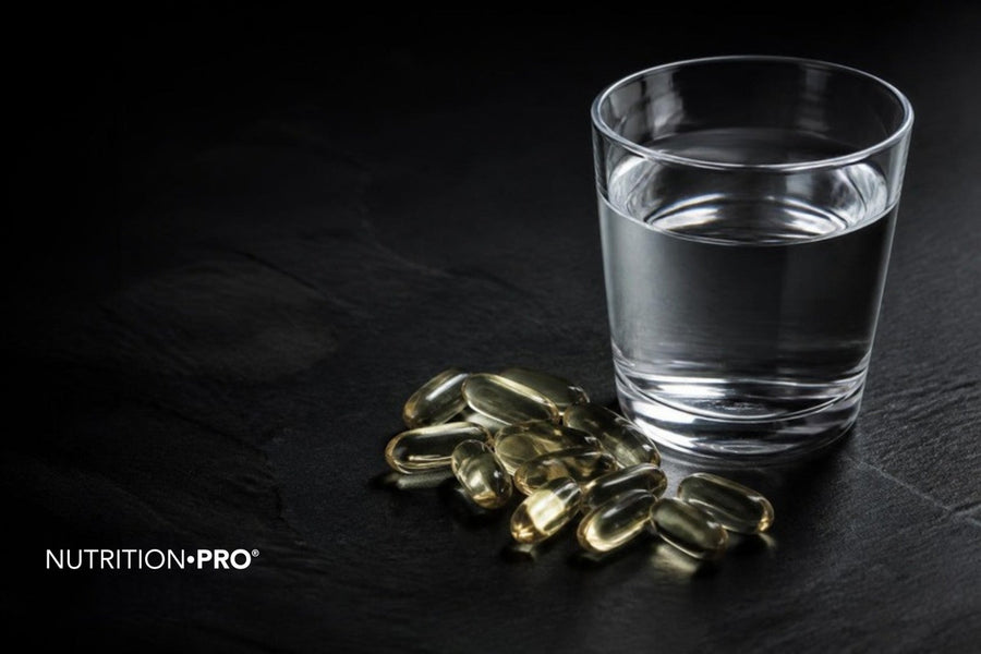 Gélules translucides et verre d eau sur une pierre sombre, acide hyaluronique en gélules dosage et danger
